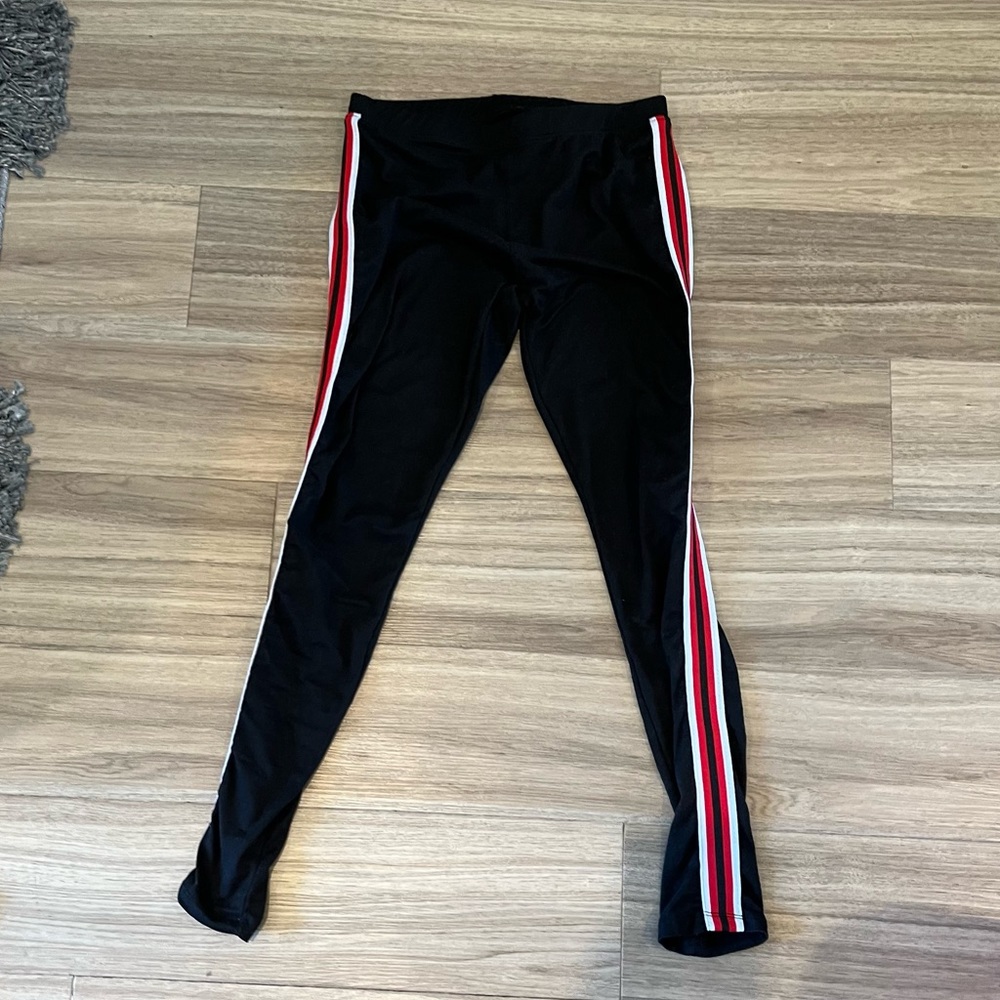 Black leggings with red and white stripe on side